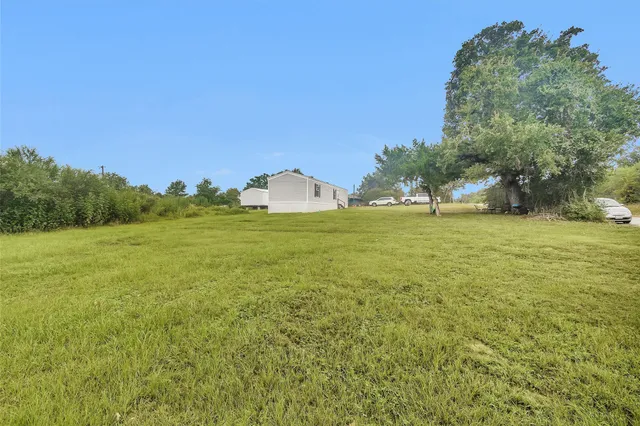 a view of a green field with clear sky