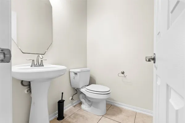 a bathroom with a sink toilet and a mirror