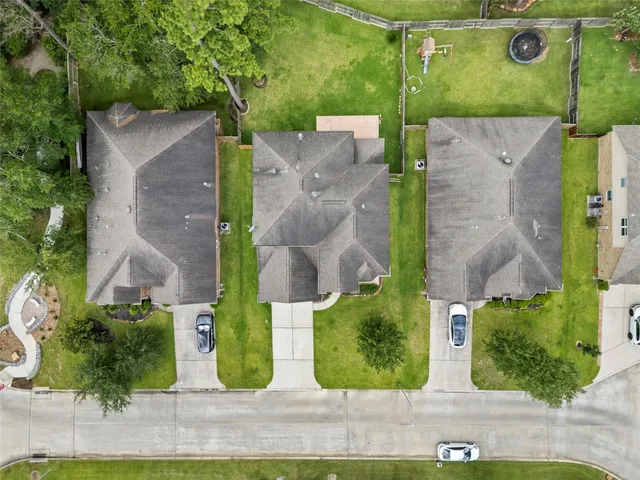an aerial view of a house with garden space and street view