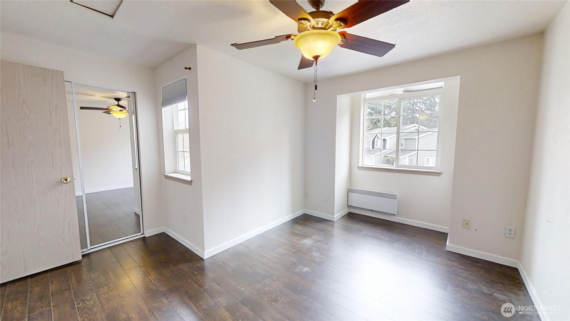 6039 Merlot Lane Southeast Lacey, WA 98513 - Photo 12 of 21 an empty room with wooden floor chandelier fan and windows