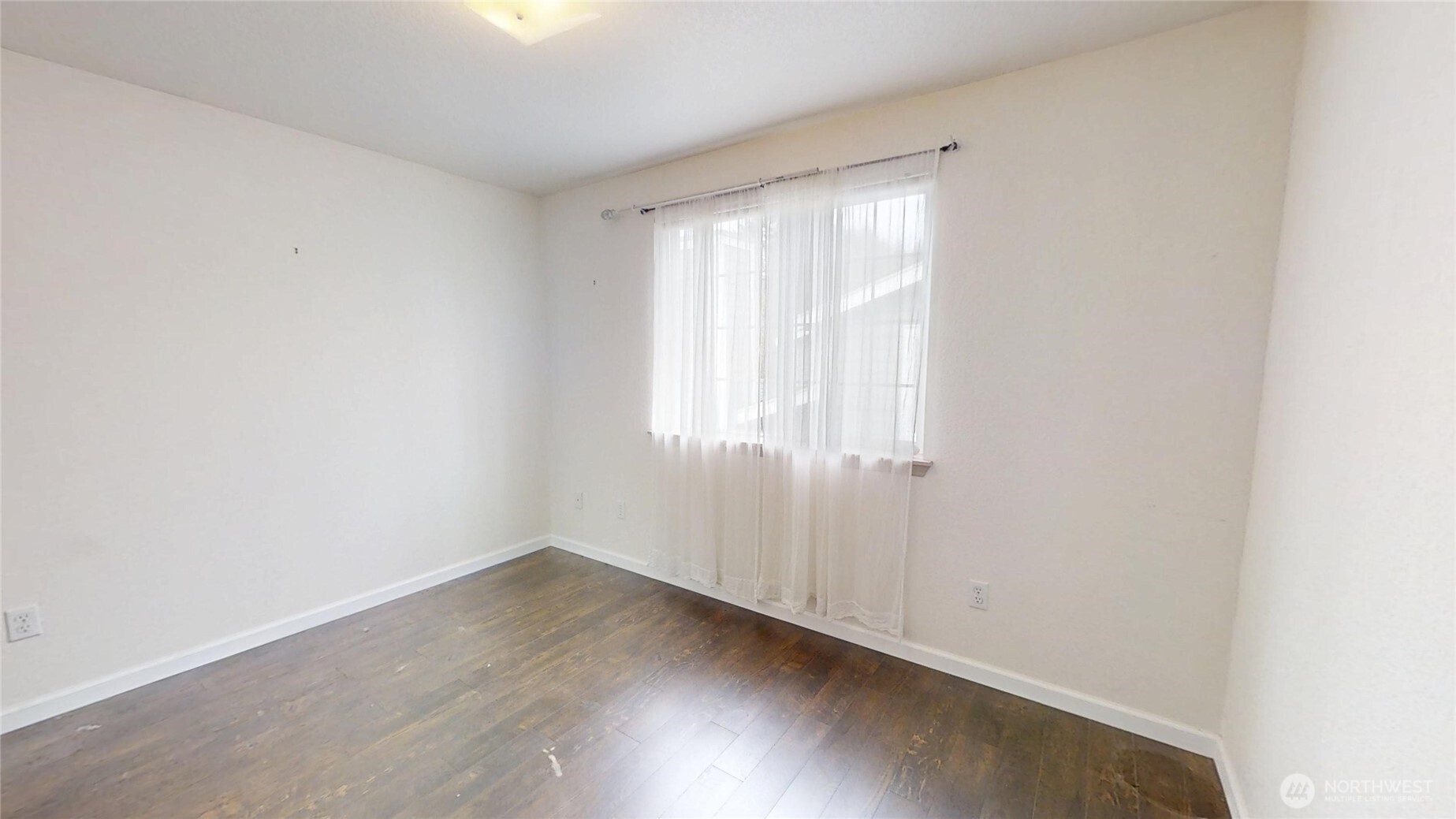 6039 Merlot Lane Southeast Lacey, WA 98513 - Photo 13 of 21 an empty room with wooden floor and windows