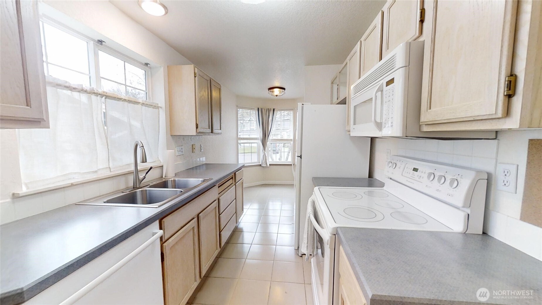 6039 Merlot Lane Southeast Lacey, WA 98513 - Photo 4 of 21 a kitchen with granite countertop a sink and cabinets