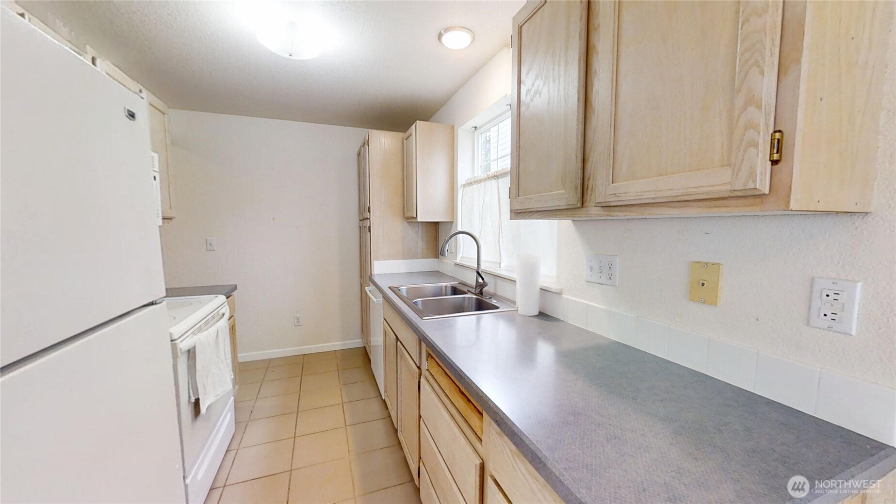 6039 Merlot Lane Southeast Lacey, WA 98513 - Photo 5 of 21 a kitchen with a sink stove and cabinets
