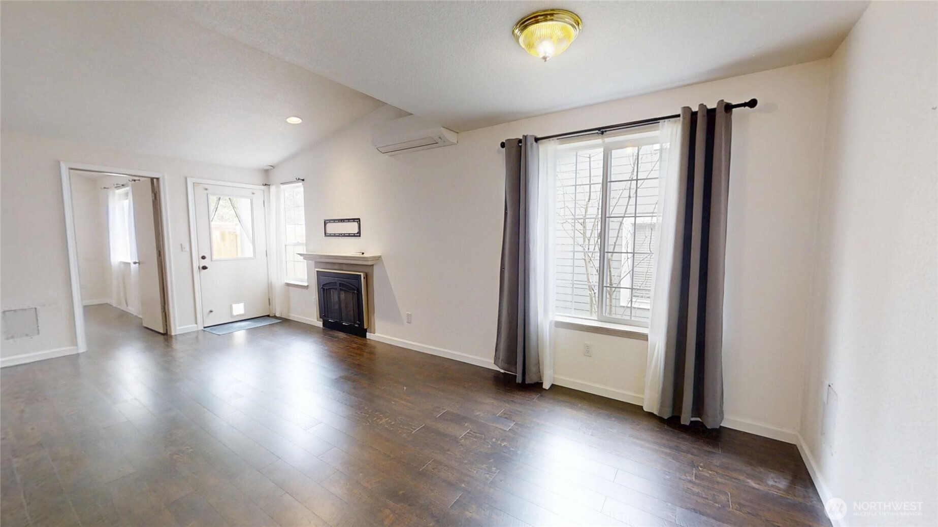 6039 Merlot Lane Southeast Lacey, WA 98513 - Photo 6 of 21 an empty room with wooden floor and fireplace