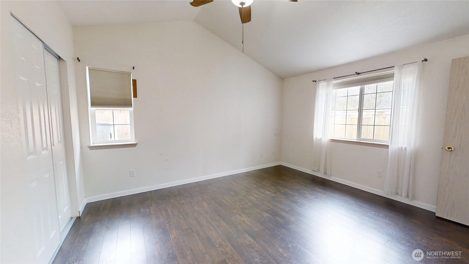 6039 Merlot Lane Southeast Lacey, WA 98513 - Photo 9 of 21 a view of an empty room with wooden floor and a window