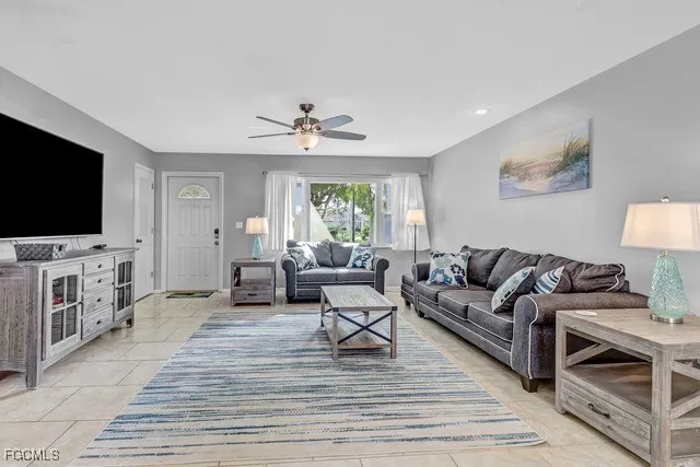 a living room with furniture and a flat screen tv