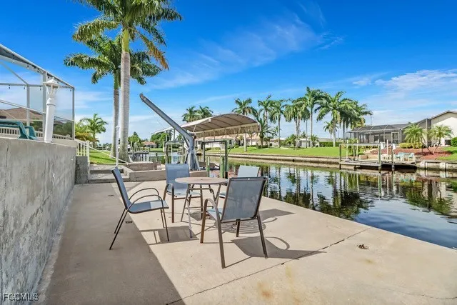 a view of a chairs and table in patio with a lake view