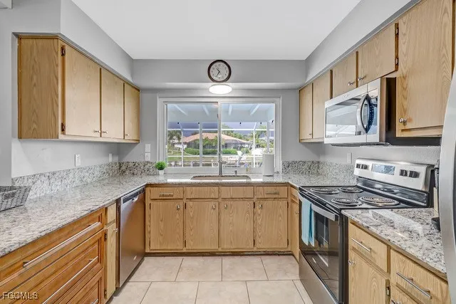 a kitchen with stainless steel appliances granite countertop a sink stove and cabinets