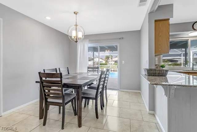 a view of a dining room with furniture window and chandelier