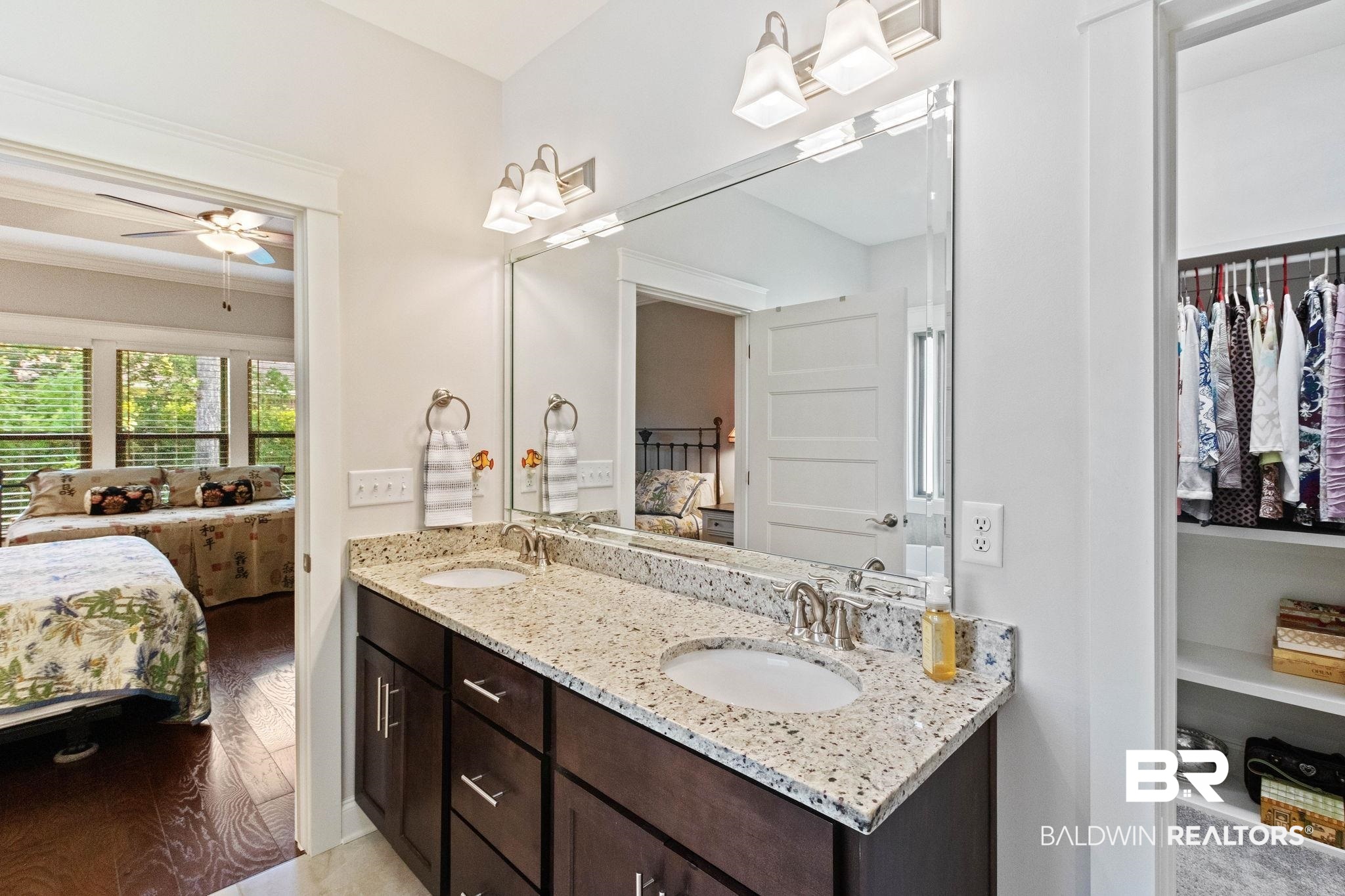 192 Mark Twain Loop Foley, AL 36535 - Photo 22 of 42 Bathroom featuring dual bowl vanity, built in features, ceiling fan, wood-type flooring, and ornamental molding