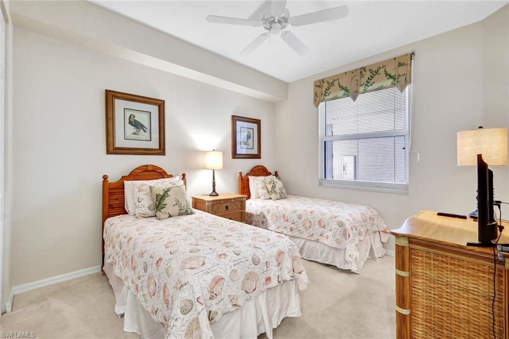 400 Flagship Drive, Unit 905 Naples, FL 34108 - Photo 11 of 26 Bedroom featuring light carpet, baseboards, and a ceiling fan