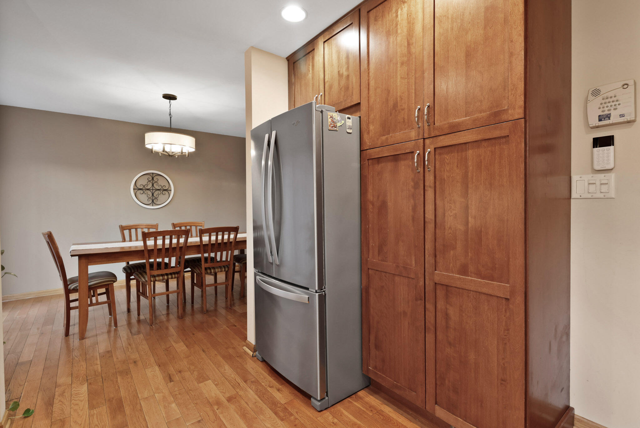 8036 Beech Avenue Munster, IN 46321 - Photo 11 of 28 a kitchen with stainless steel appliances granite countertop a refrigerator a stove a dining table and chairs with wooden floor
