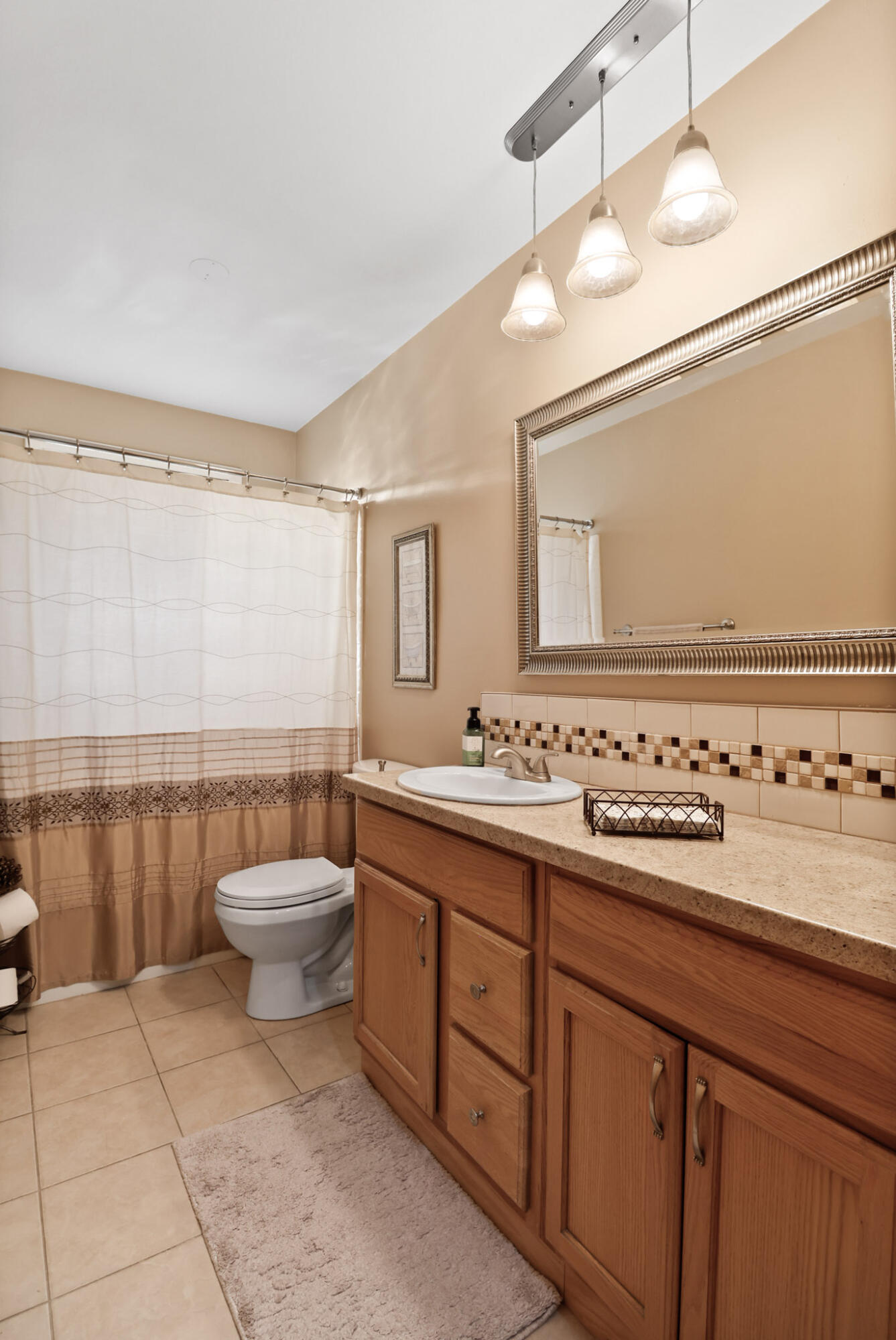 8036 Beech Avenue Munster, IN 46321 - Photo 17 of 28 a bathroom with a toilet sink and mirror