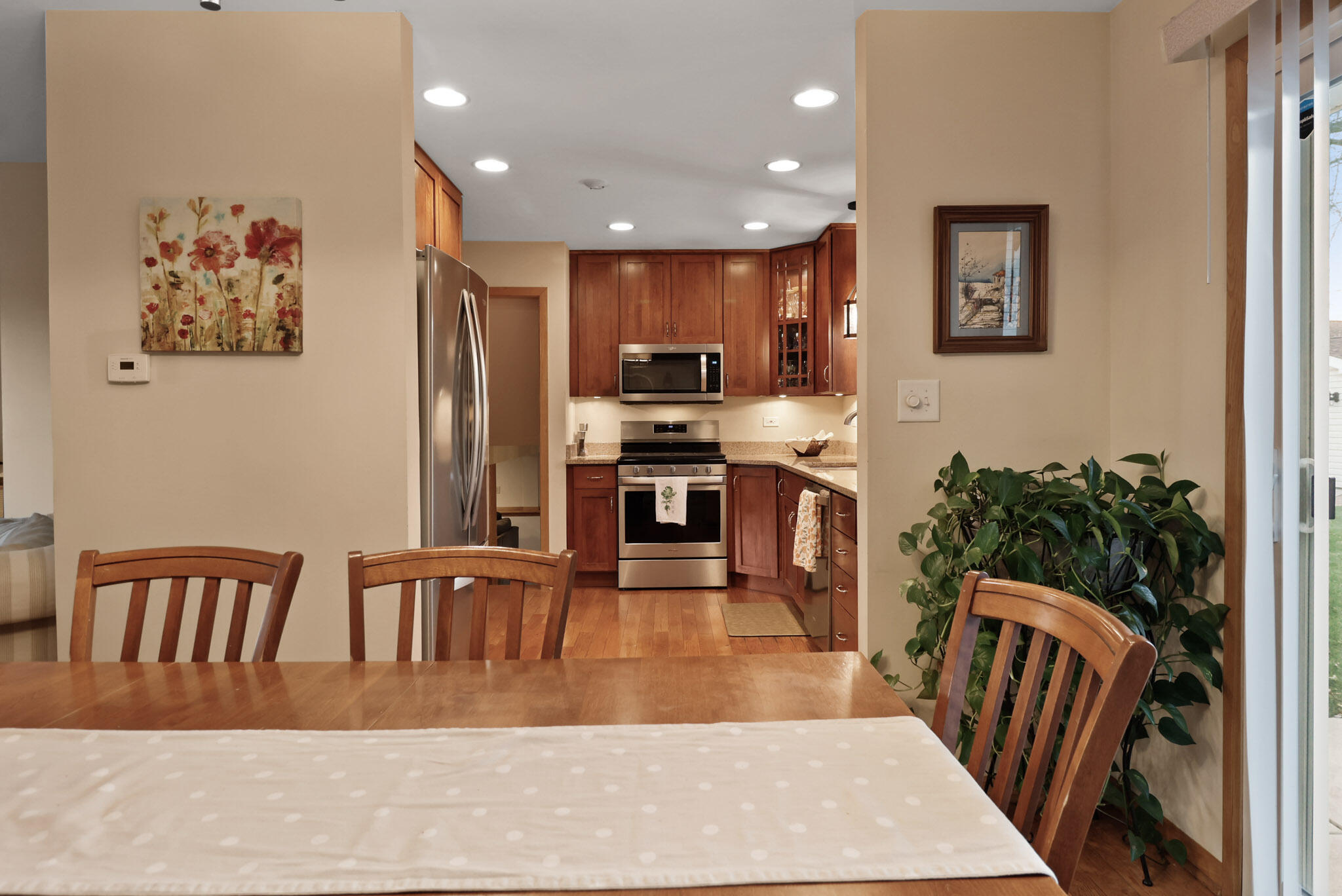 8036 Beech Avenue Munster, IN 46321 - Photo 8 of 28 a kitchen with stainless steel appliances granite countertop a stove top oven a sink a dining table and chairs