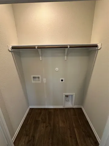a view of a room with wooden floor and cabinets