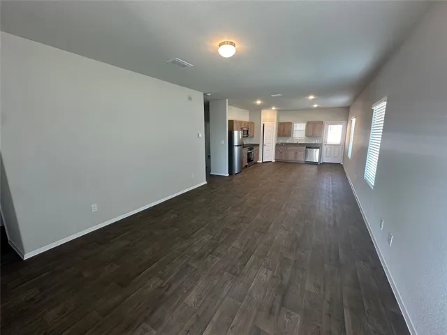 a view of a room with wooden floor