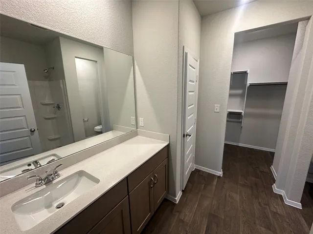 a spacious bathroom with a double vanity sink and a mirror