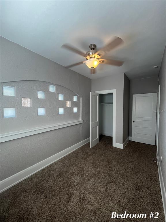 3303 West Empedrado Street, Unit 4 Tampa, FL 33629 - Photo 15 of 16 an empty room with windows and chandelier