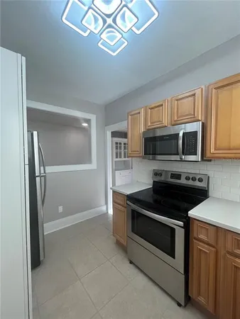 a kitchen with stainless steel appliances granite countertop a stove microwave and sink