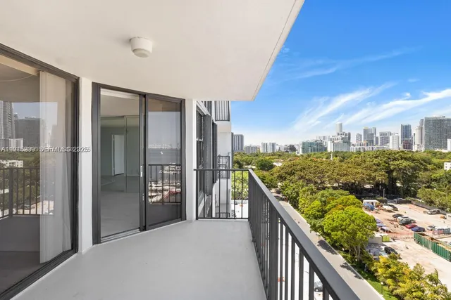 a view of a living room and kitchen with furniture