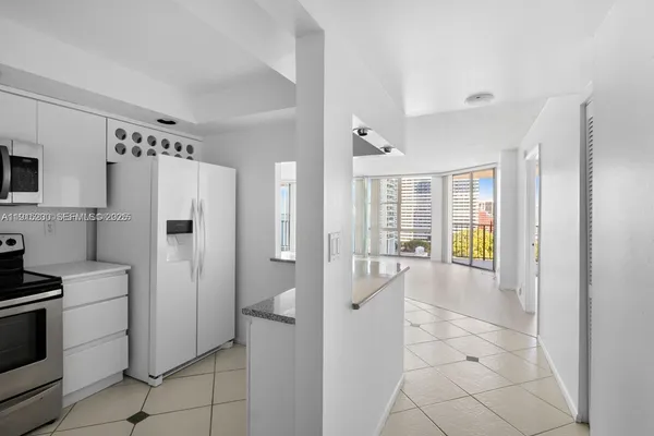 a kitchen with stainless steel appliances a refrigerator and a stove top oven