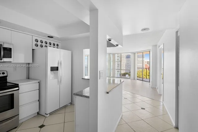 a kitchen with stainless steel appliances a refrigerator and a stove top oven