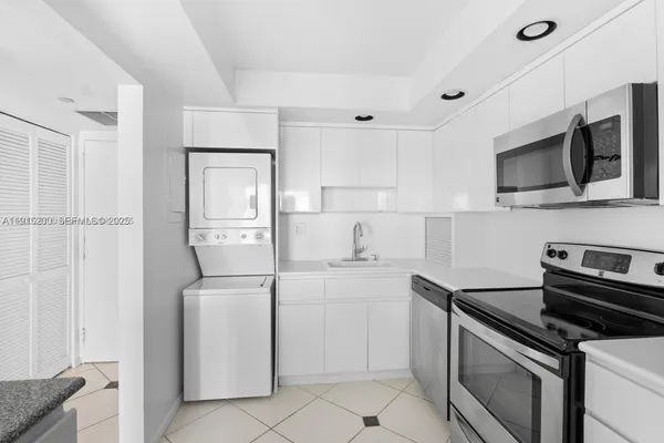 a kitchen with a sink and steel appliances