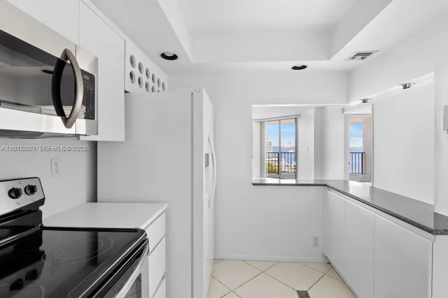 a kitchen with a refrigerator and a stove