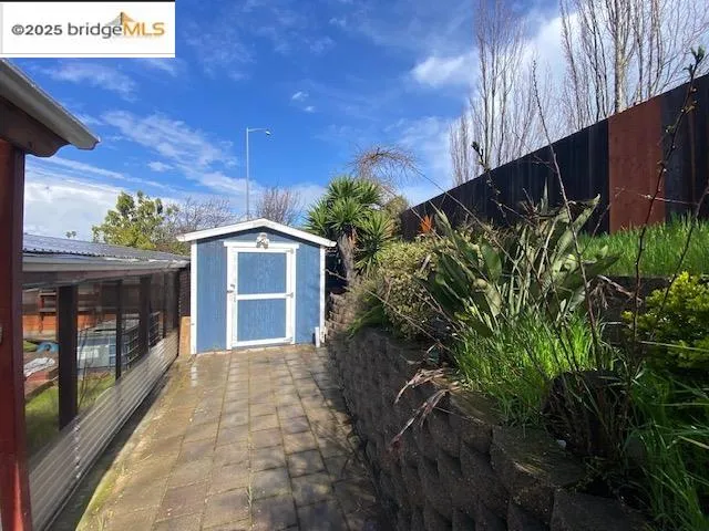 a backyard of a house with plants and outdoor seating
