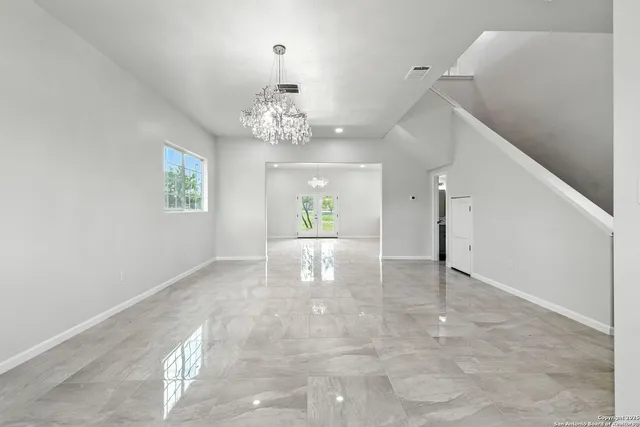 an empty room with windows and closet