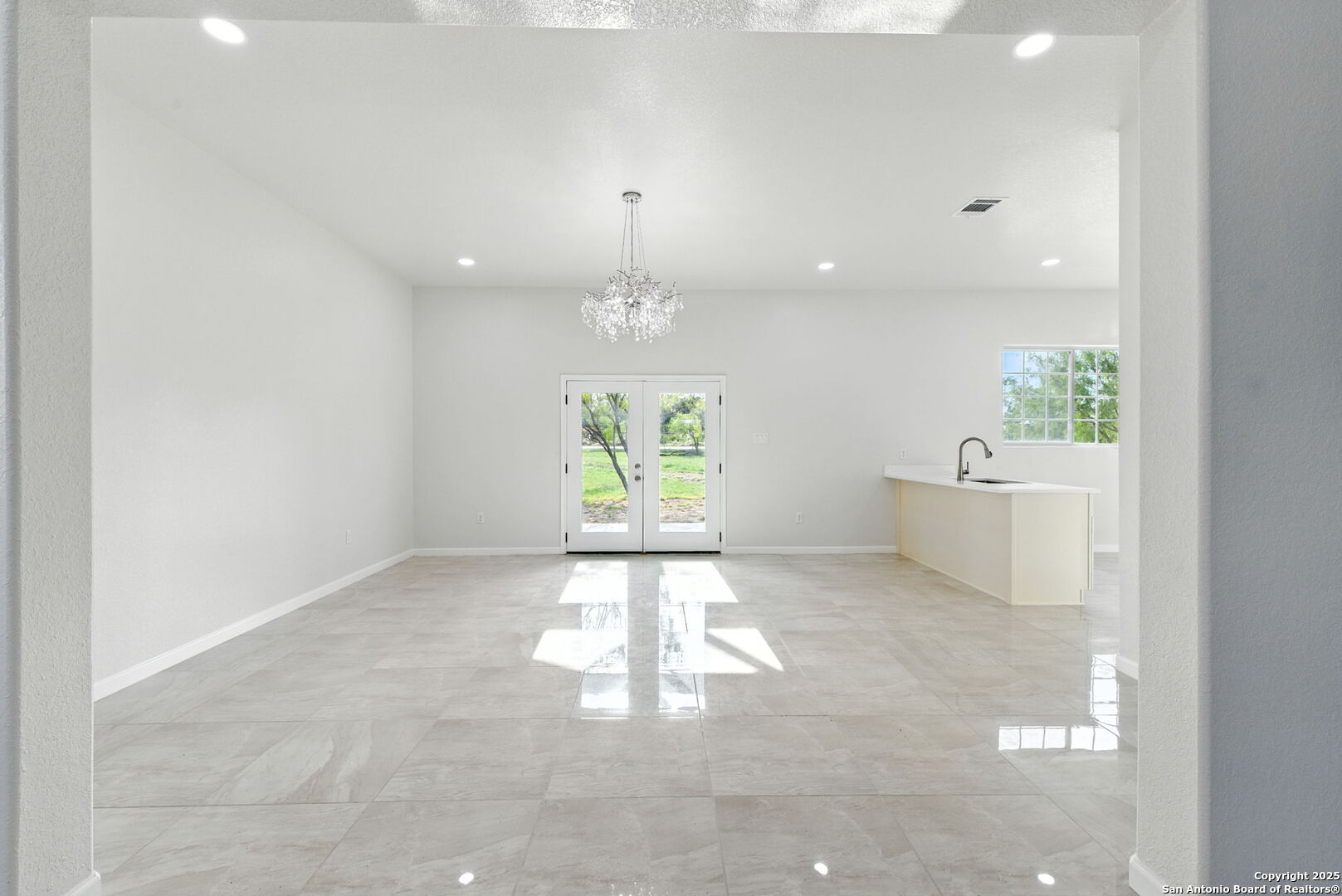 774 County Road 6843 Lytle, TX 78052 - Photo 21 of 63 en empty room with windows and chandelier