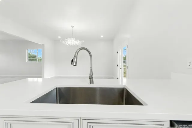 a kitchen that has a sink and a stove