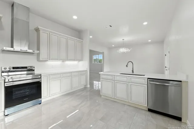 an empty room with windows and ceiling fan