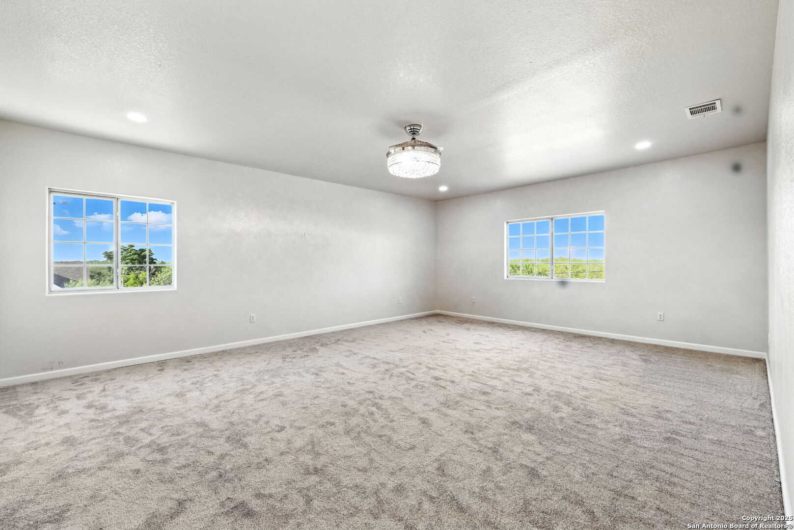 774 County Road 6843 Lytle, TX 78052 - Photo 35 of 63 an empty room with windows and ceiling fan