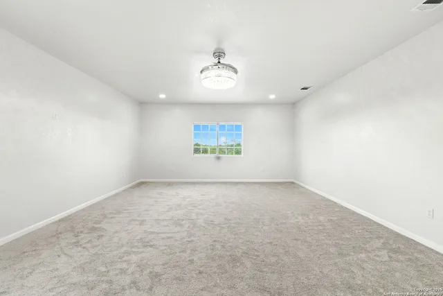 an empty room with a mirror