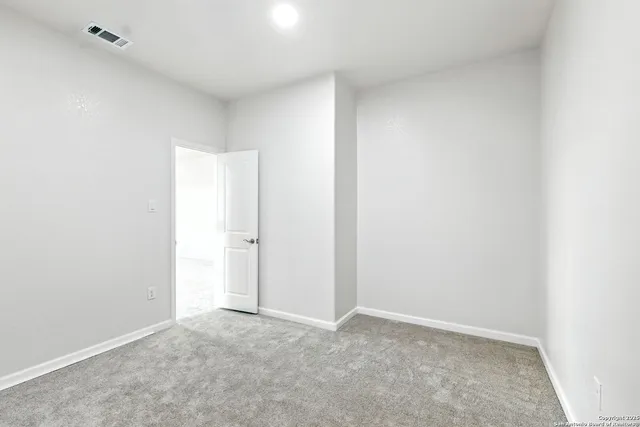 an empty room with a fan