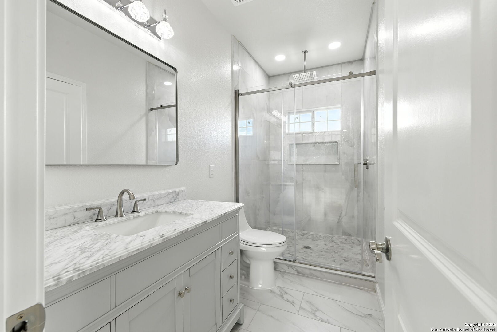 774 County Road 6843 Lytle, TX 78052 - Photo 43 of 63 a bathroom with a granite countertop sink a toilet and shower