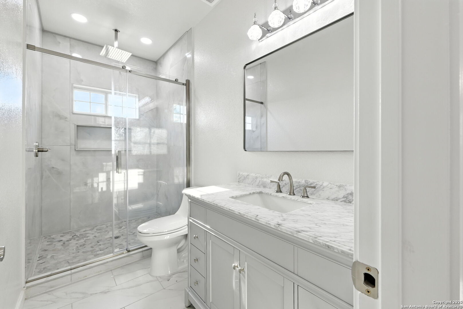774 County Road 6843 Lytle, TX 78052 - Photo 44 of 63 a bathroom with a granite countertop sink a toilet a mirror and shower