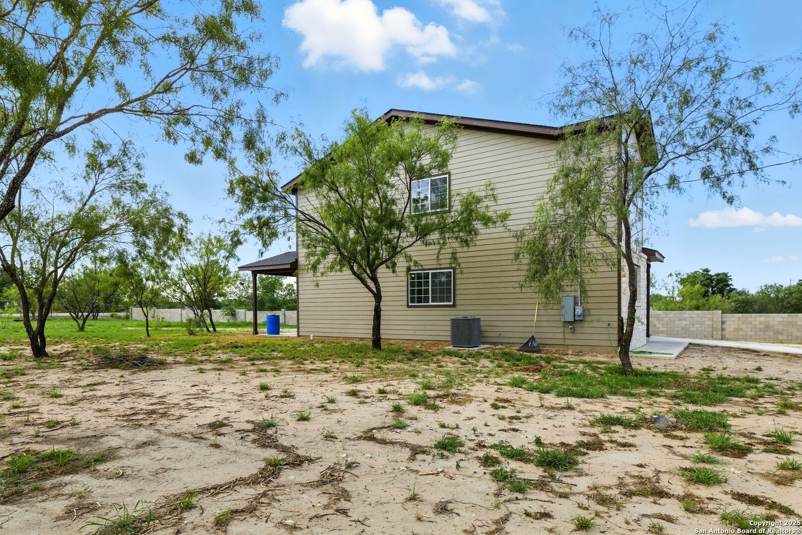 774 County Road 6843 Lytle, TX 78052 - Photo 7 of 63 a view of a house with a yard