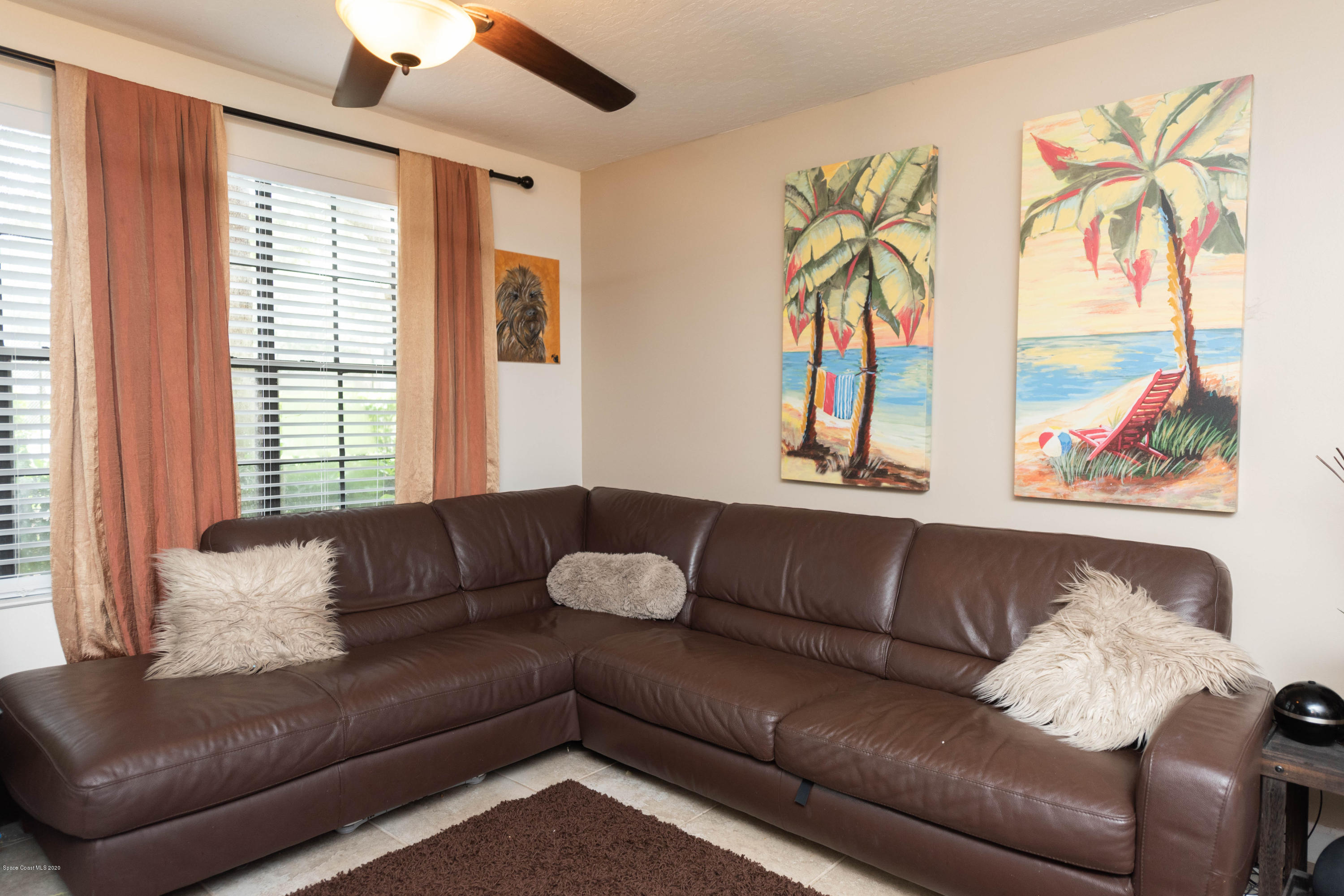 7667 North Wickham Road, Unit 802 Melbourne, FL 32940 - Photo 3 of 12 a living room with furniture and a large window