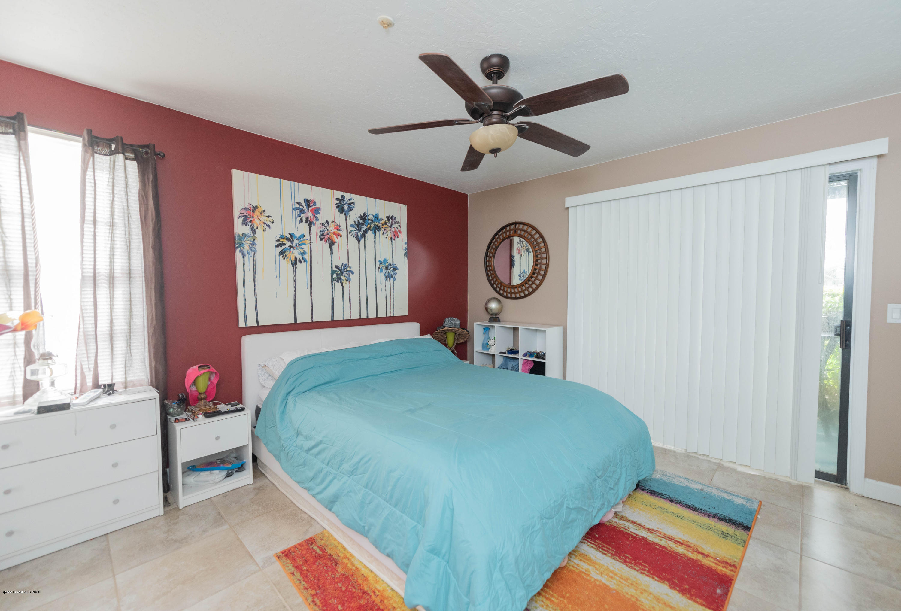 7667 North Wickham Road, Unit 802 Melbourne, FL 32940 - Photo 6 of 12 a bedroom with a large bed and a chandelier
