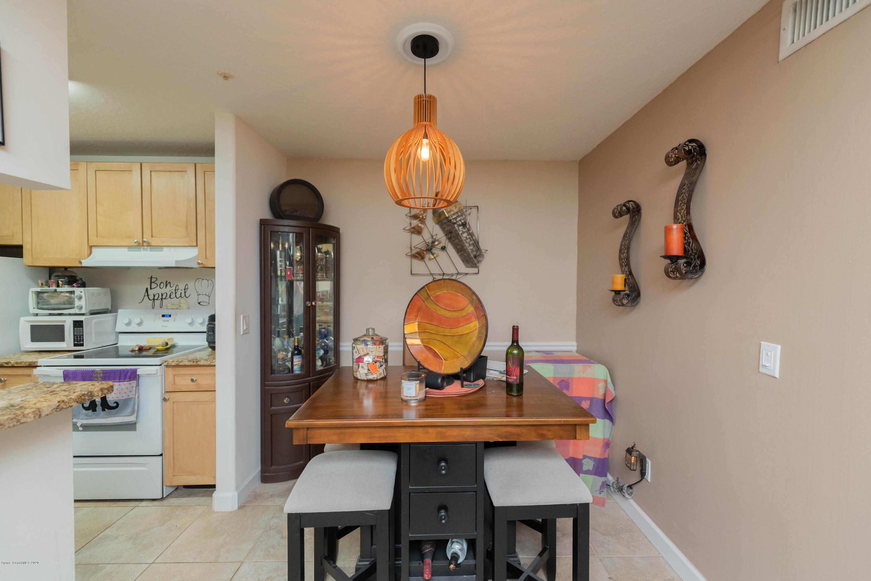 7667 North Wickham Road, Unit 802 Melbourne, FL 32940 - Photo 7 of 12 a view of a kitchen area with furniture and chandelier