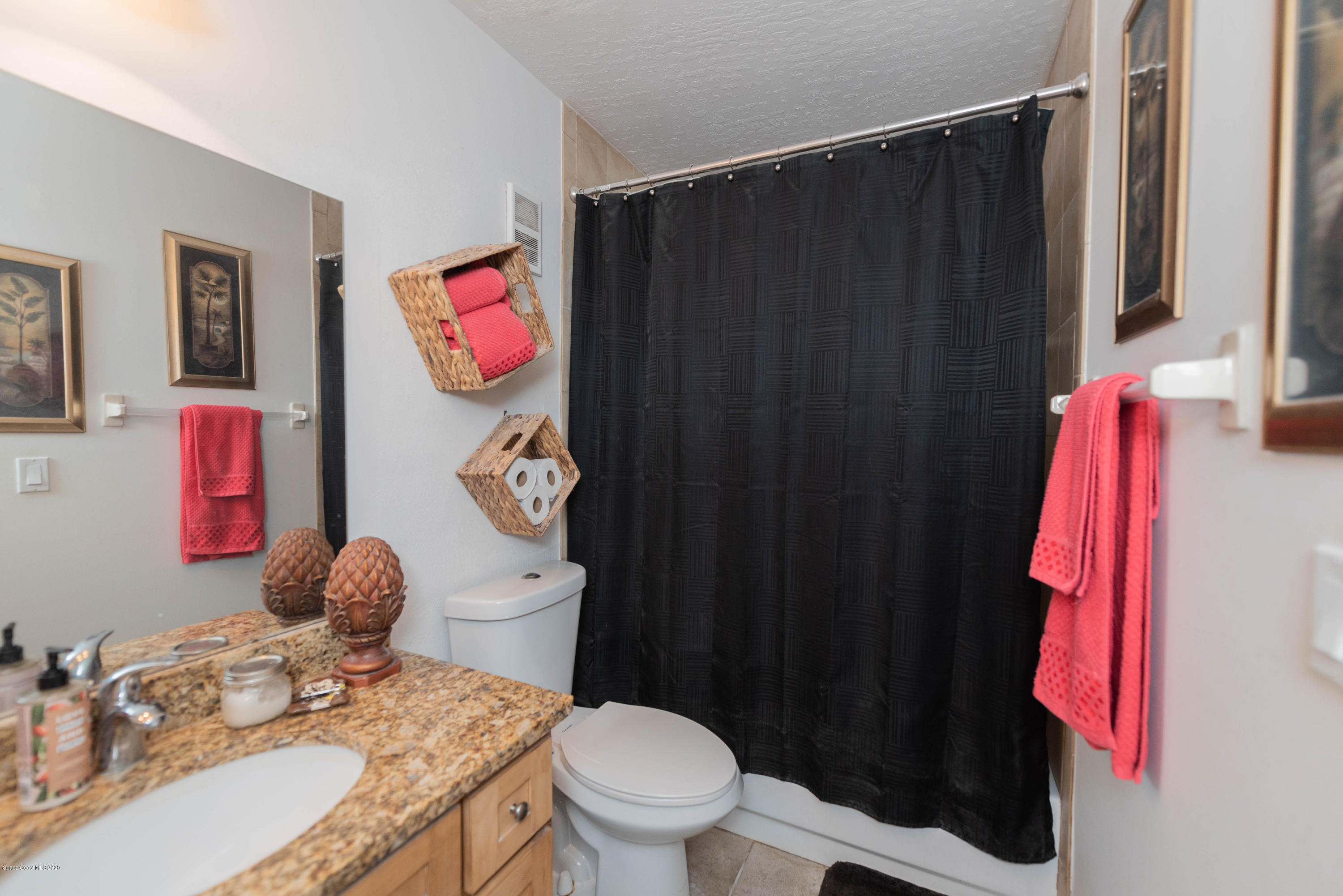 7667 North Wickham Road, Unit 802 Melbourne, FL 32940 - Photo 8 of 12 a bathroom with a sink vanity mirror and toilet