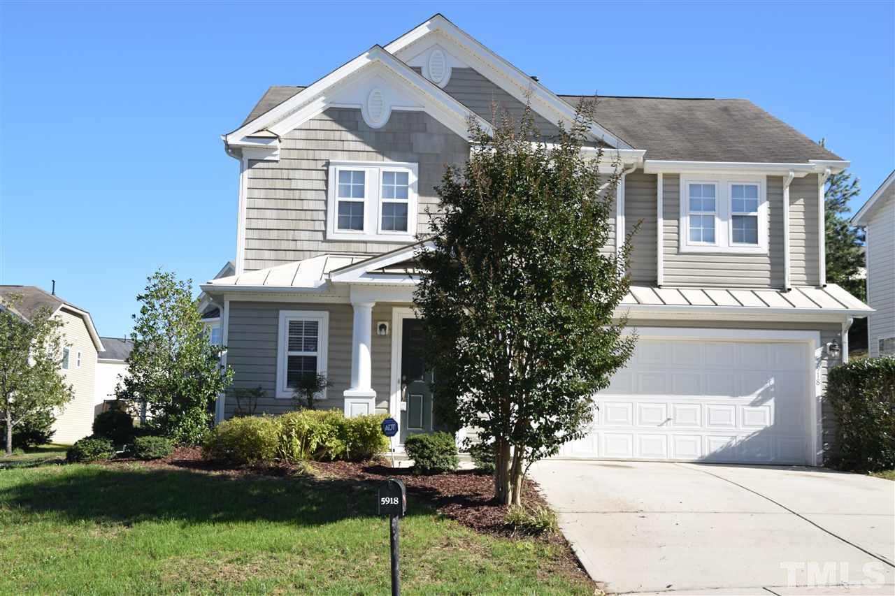 5918 Ricker Road Raleigh, NC 27610 - Photo 1 of 8 a front view of a house with a yard and potted plants