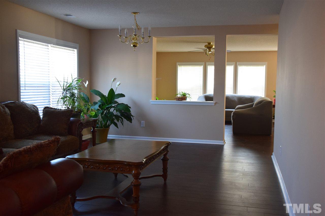 5918 Ricker Road Raleigh, NC 27610 - Photo 2 of 8 a living room with furniture and a potted plant