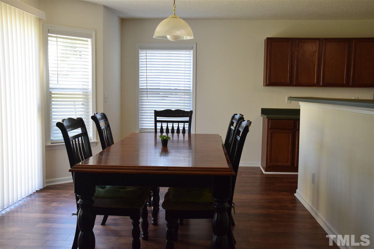 5918 Ricker Road Raleigh, NC 27610 - Photo 4 of 8 a view of a dining room with furniture window and wooden floor