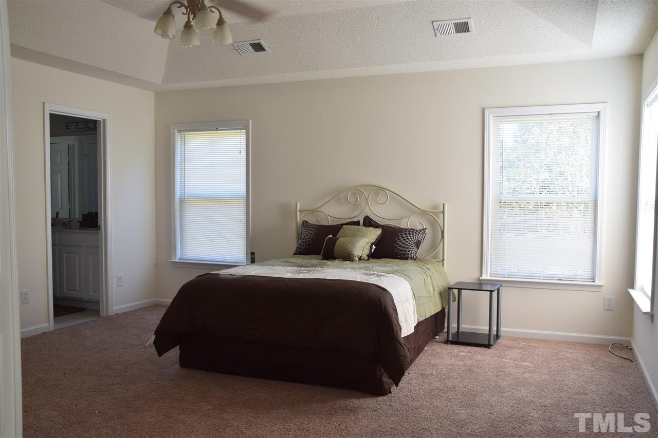5918 Ricker Road Raleigh, NC 27610 - Photo 5 of 8 a bedroom with a bed and a window