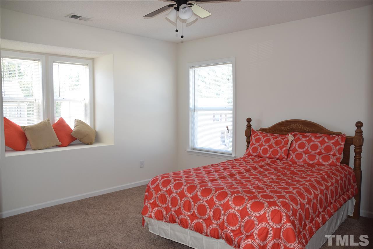 5918 Ricker Road Raleigh, NC 27610 - Photo 6 of 8 a bedroom with a bed and window