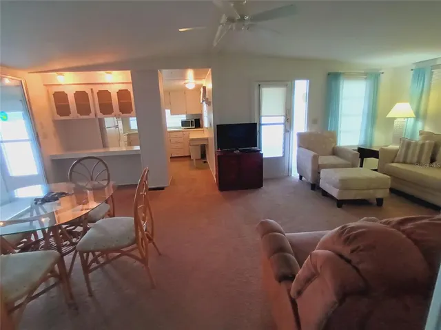 a dining room with furniture and wooden floor