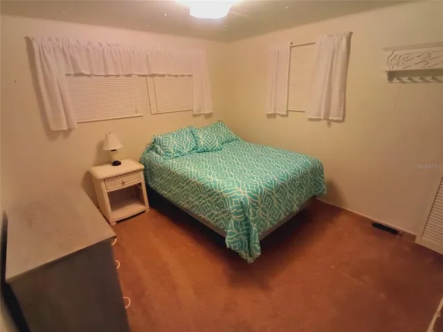 a living room with furniture a rug and a flat screen tv